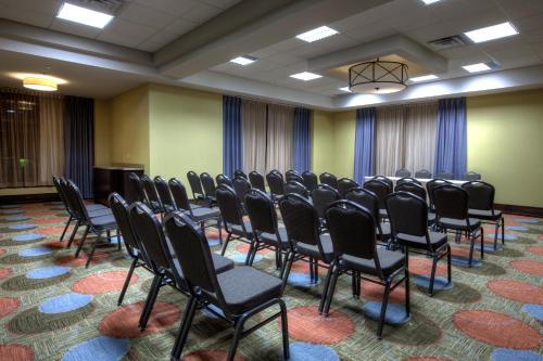 a conference room with chairs and a podium at Staybridge Suites Hamilton - Downtown by IHG in Hamilton
