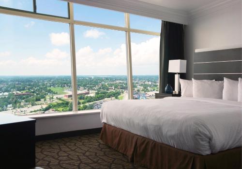 a hotel room with a large bed and a large window at Tower Hotel at Fallsview in Niagara Falls