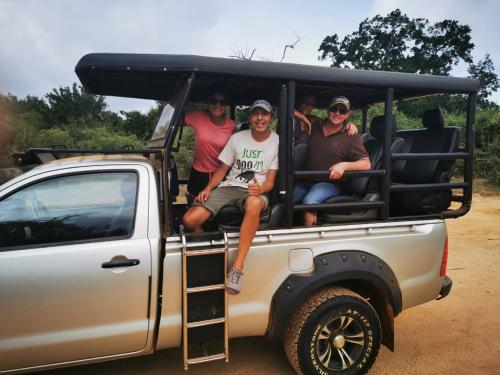 a group of people sitting in the back of a truck at Lavender Home Yala Safari in Tissamaharama