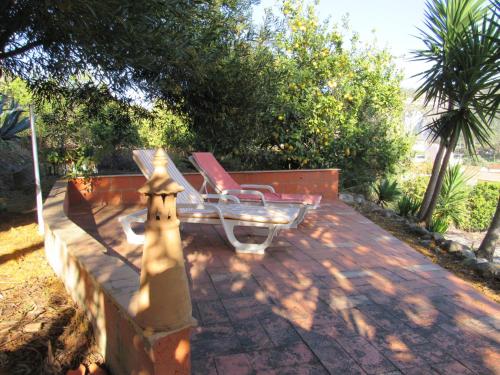 a couple of chairs sitting on a patio at My House - Casa Charme in Monchique