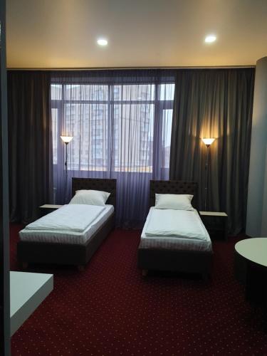 a hotel room with two beds and a window at LEX Trend Hotel in Irpin'