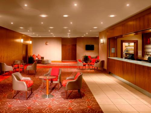 a lobby of a hotel with chairs and tables at Radisson Blu Hotel, Durham in Durham