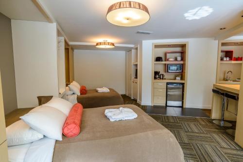 a hotel room with two beds and a kitchen at Bow View Lodge in Banff