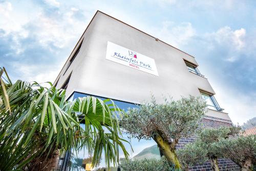 a building with a sign on the side of it at Motel Rheinfels Park in Stein