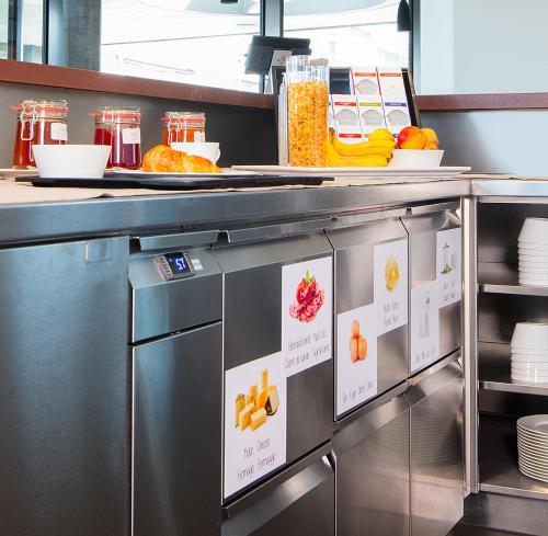 a kitchen with a counter with some food at Motel Rheinfels Park in Stein