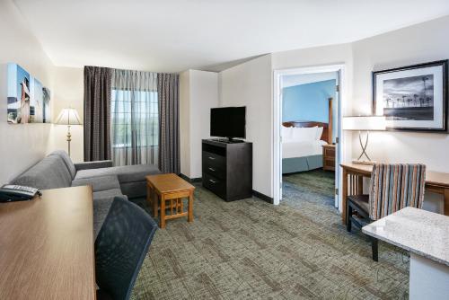 a hotel room with a couch and a bed at Staybridge Suites Austin Round Rock by IHG in Round Rock
