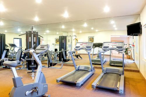 a gym with several tread machines and a mirror at Staybridge Suites - Brownsville by IHG in Brownsville