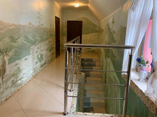 a stairway with a painting on the wall at Hotel Kalyna in Bukovel