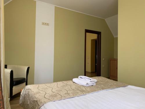 a bedroom with a bed with two towels on it at Hotel Kalyna in Bukovel