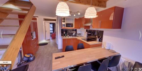 Una cocina con gabinetes de madera y una mesa de madera. en Appartement 5 pièces à ISOLA 2000, en Isola 2000