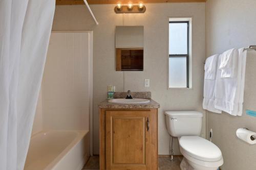 a bathroom with a sink and a toilet and a tub at Sierra Meadows Ranch in Mammoth Lakes