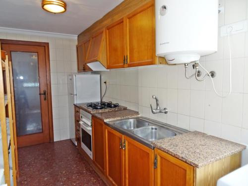 a small kitchen with a sink and a refrigerator at ROMA XII - Apartamento Familiar in Playa de Gandia