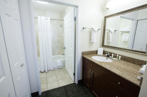 a bathroom with a sink and a mirror at Staybridge Suites Austin Airport by IHG in Austin