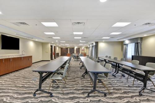 a conference room with tables and chairs and a tv at Staybridge Suites Mt Juliet - Nashville Area in Mount Juliet