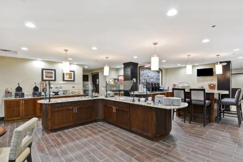 a large kitchen with a bar and a restaurant at Staybridge Suites Mt Juliet - Nashville Area in Mount Juliet