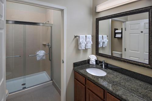 a bathroom with a sink and a shower and a mirror at Staybridge Suites Austin Northwest, an IHG Hotel in Austin