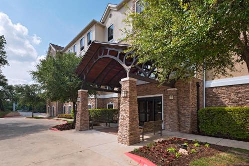 a building with an archway in front of it at Staybridge Suites Austin Northwest by IHG in Austin