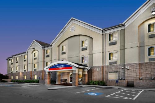 an empty parking lot in front of a hotel at Candlewood Suites Conway by IHG in Conway