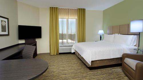 A bed or beds in a room at Candlewood Suites - Frisco, an IHG Hotel