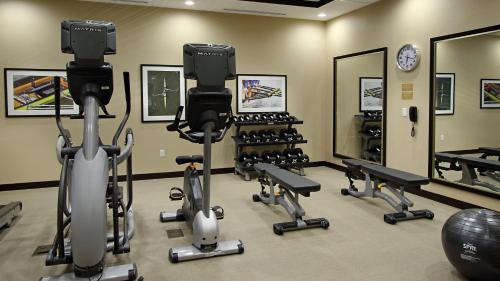 a gym with several exercise bikes and a mirror at Candlewood Suites - Frisco by IHG in Frisco