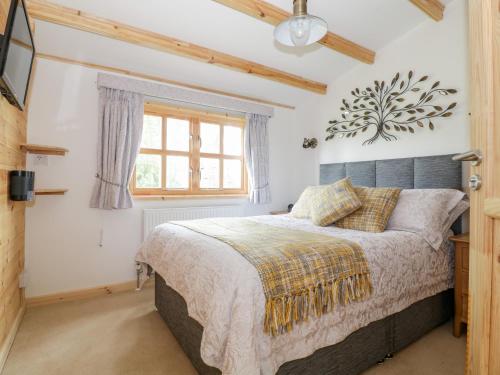 a bedroom with a bed and a window at Someplace Else in Diss