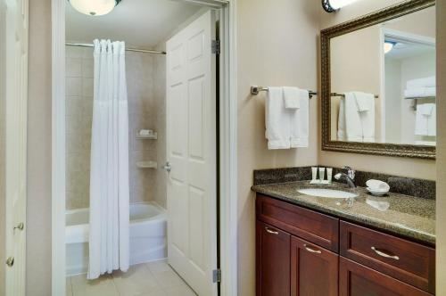 a bathroom with a sink and a shower at Staybridge Suites Oakville Burlington, an IHG Hotel in Oakville