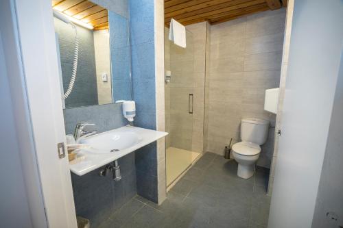 a bathroom with a sink and a toilet at Hotel Restaurant Les Brases in Sort