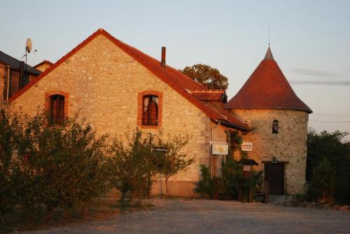 an old brick building with a tower at Domaine de Vareilles in Vareilles