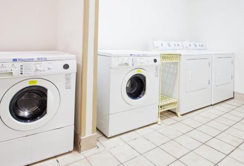 three washing machines and a washer and dryer in a room at Homewood Suites by Hilton Atlanta Buckhead Pharr Road in Atlanta