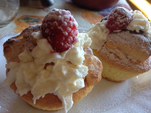 two donuts with whipped cream and a raspberry on them at Sadyba Ertash in Vyshka