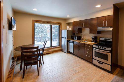 a kitchen with a table and chairs and a window at Breakaway West - Studio, 2,3 Bedrooms by Vail Realty in Vail