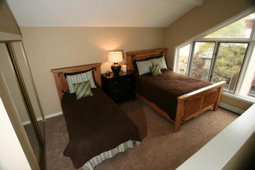 a bedroom with two beds and a window at Breakaway West - Studio, 2,3 Bedrooms by Vail Realty in Vail