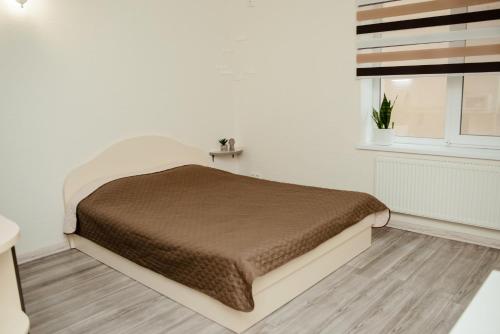 a bedroom with a bed and a window at Apartments at Kontorska 10 in Kharkiv
