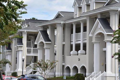 a large white building with columns at Brunswick Plantation Villa 1005 in Calabash