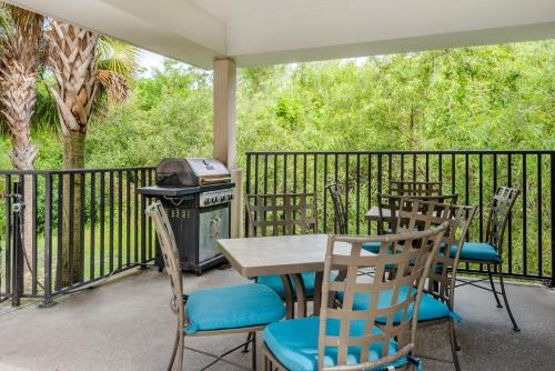 a patio with a table and chairs and a grill at Candlewood Suites Fort Myers/Sanibel Gateway by IHG in Fort Myers