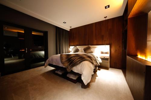 a bedroom with a large bed in a room at Cave Hotel & Golf Resort in Faversham