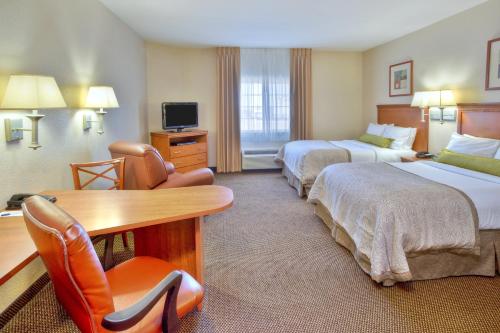 a hotel room with two beds and a desk at Candlewood Suites Fort Stockton by IHG in Fort Stockton