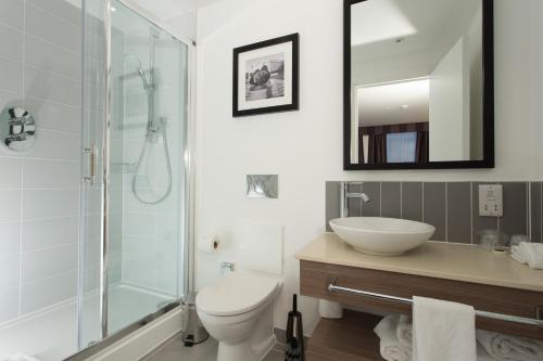 uma casa de banho com um WC, um lavatório e um chuveiro em Staybridge Suites Birmingham, an IHG Hotel em Birmingham