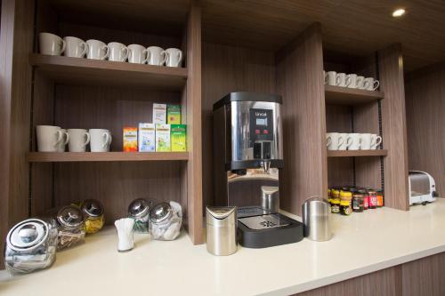 a kitchen with a coffee maker on a counter at Staybridge Suites Birmingham by IHG in Birmingham