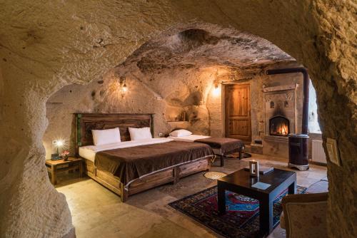 A bed or beds in a room at Atilla's Cave Hotel