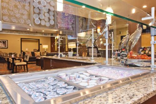 a buffet line with dishes on display in a restaurant at Staybridge Suites Austin South Interstate Hwy 35 by IHG in Austin