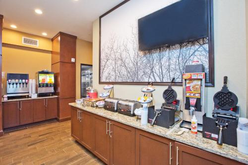 a restaurant with a large screen on the wall at Staybridge Suites Austin South Interstate Hwy 35 by IHG in Austin