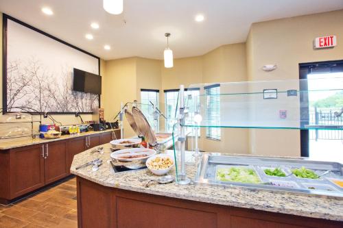 a kitchen with a counter with food on it at Staybridge Suites Austin South Interstate Hwy 35 by IHG in Austin