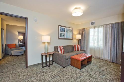 a living room with a couch and a chair at Staybridge Suites Austin South Interstate Hwy 35 by IHG in Austin