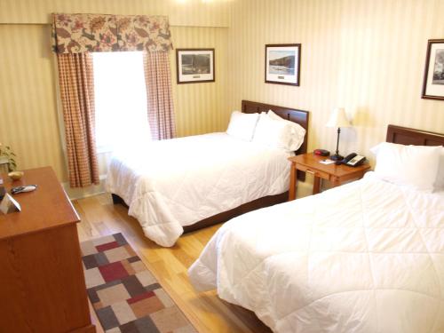 a hotel room with two beds and a window at Shawnee Inn and Golf Resort in East Stroudsburg