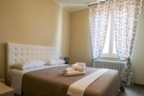 a bedroom with a bed with two stuffed animals on it at Casa Myriam in Verona