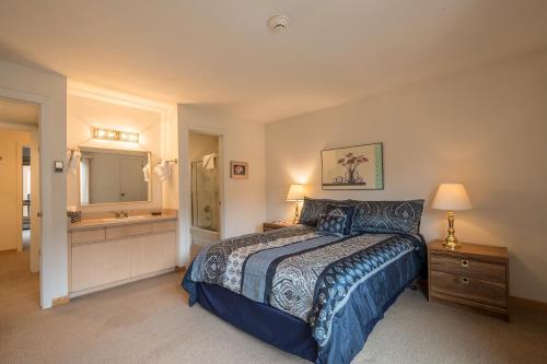 a bedroom with a bed and a sink and a mirror at Breakaway West - Studio, 2,3 Bedrooms by Vail Realty in Vail