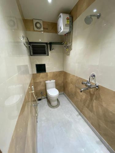 a bathroom with a toilet and a sink at Shivam Hotels in Kolkata