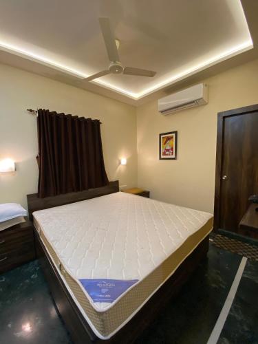 a bedroom with a bed in a room at Shivam Hotels in Kolkata