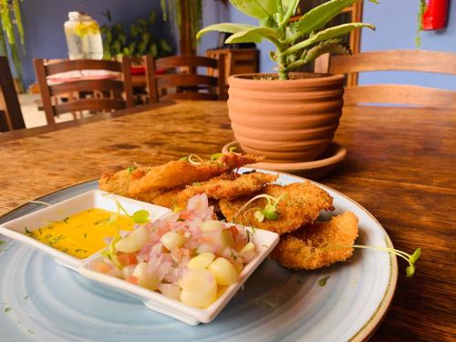 a plate of food on a wooden table with food at Casa Hacienda San Jose in Chincha Alta